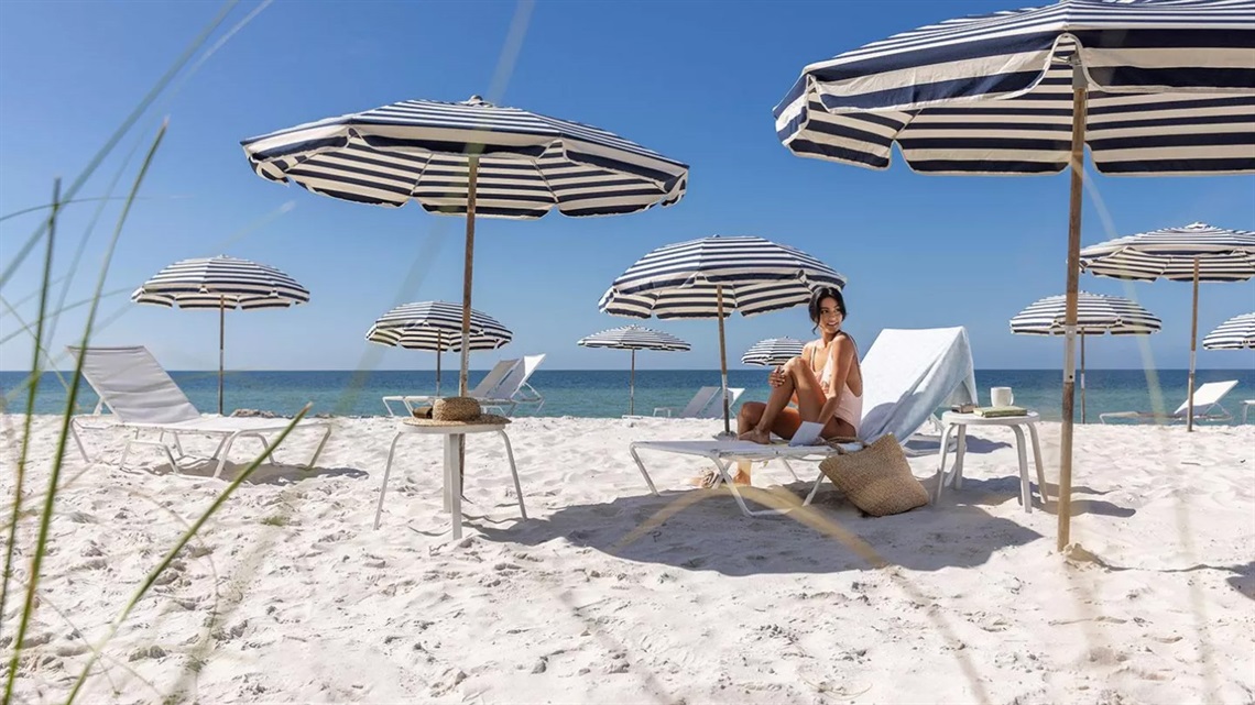 Woman Lounging on the Beach at Edgewater Beach Hotel