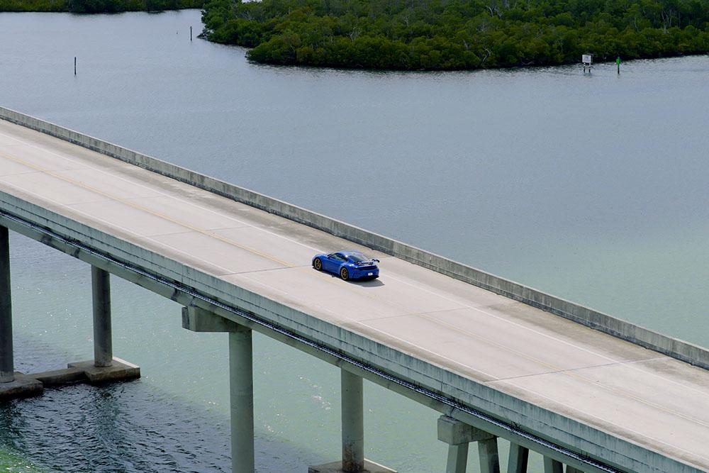 Porsche Driving Down the Road in Naples