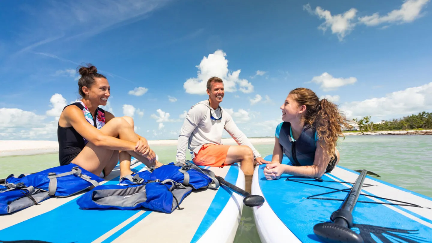 Family Sitting on Stand Up Paddleboards