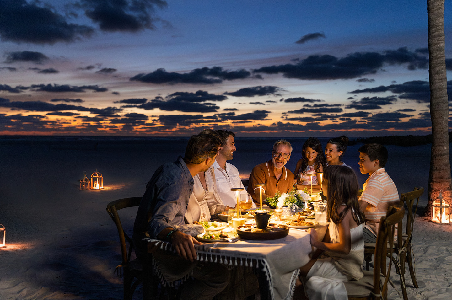 Family Dining on the Beach at Sunset