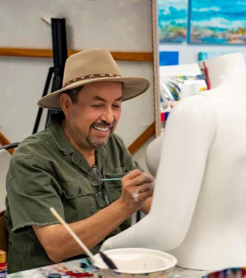 Man painting a bust Man painting a bust