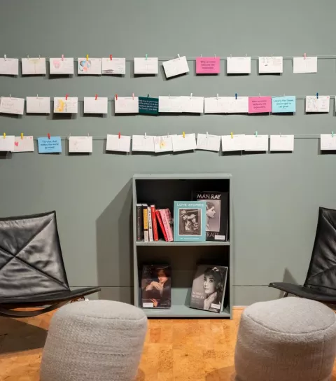 Art is displayed on a gallery wall.