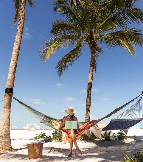 Woman at beach with laptop