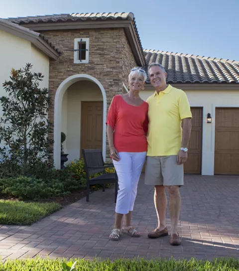 Couple in front of property for filming