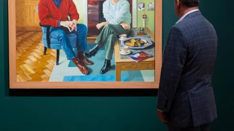 Man views a piece of art in a gallery. Man views a piece of art in a gallery.