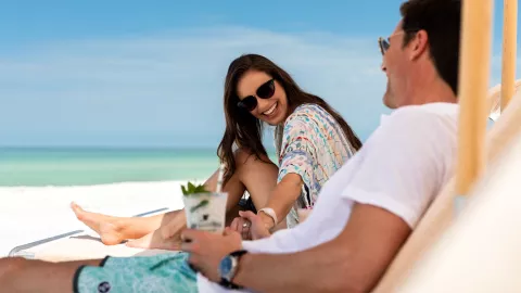 Couple on beach with drinks