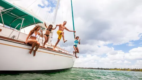 Family jumping from a Sailboat.