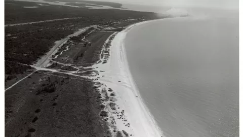 A black and white photo of a coastline.