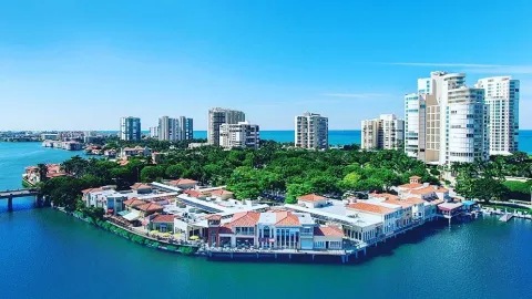 An aerial view of homes along the water with high