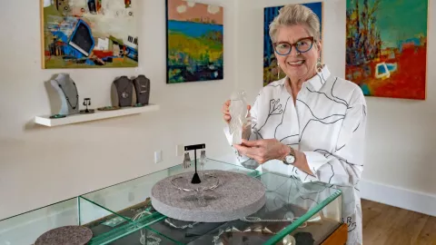Artist holding sculpture in art gallery