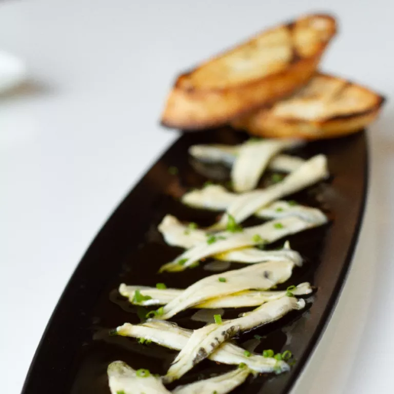 Boquerones. Imported marinated white anchovies served in olive oil & garlic bread Photo 4