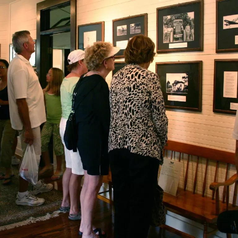 Visitors Viewing Archival Photos in Palm Cottage Photo 3