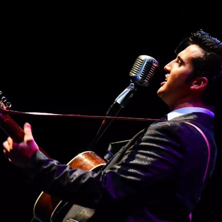 Image of Brandon Bennett dressed as Elvis Presley during a performance Photo