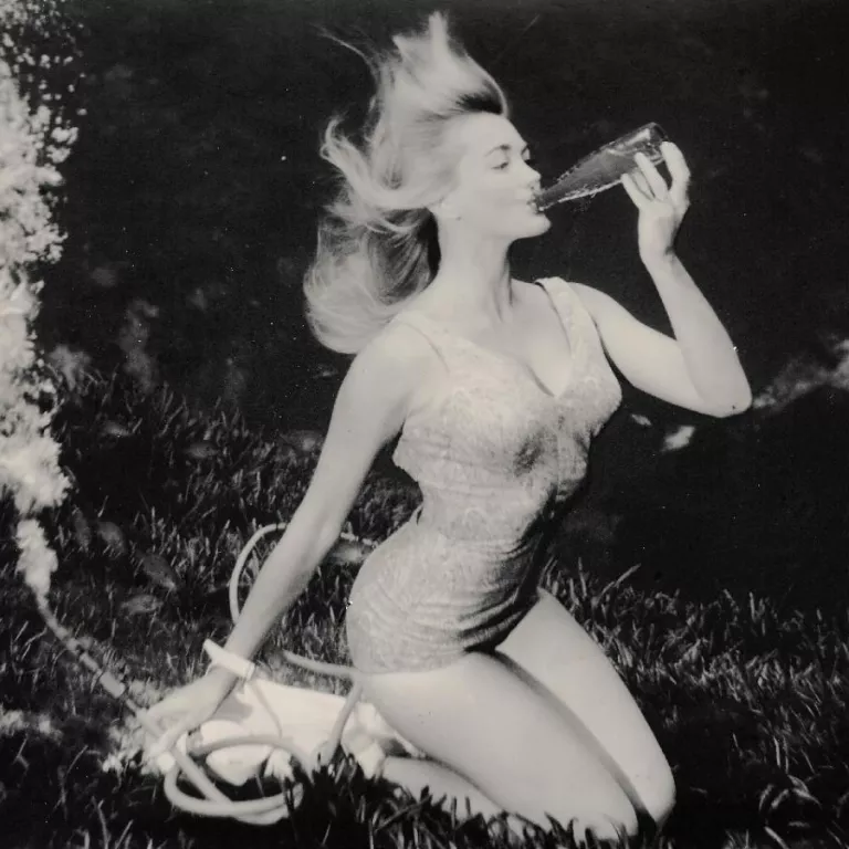 Black and White, Woman in a bathing suit blowing a conch shell Photo