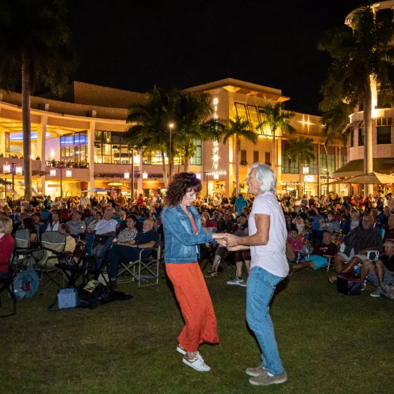 Couple dancing at a concert on the event lawn at Mercato Photo