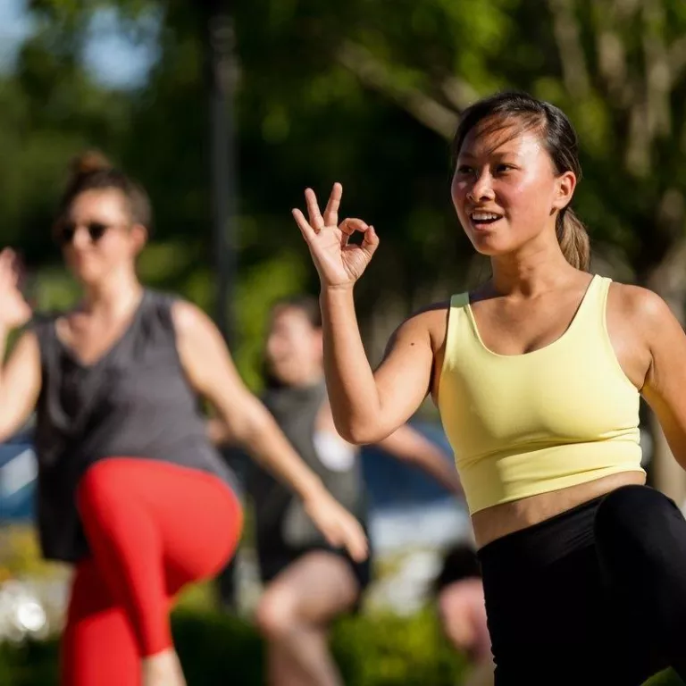 female working out during outdoor fitness class Photo
