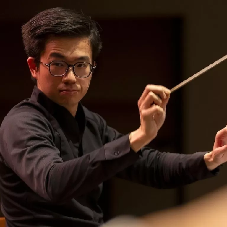 Alvin Ho, conductor. Photo Courtesy of ArtisꟷNaples Photo