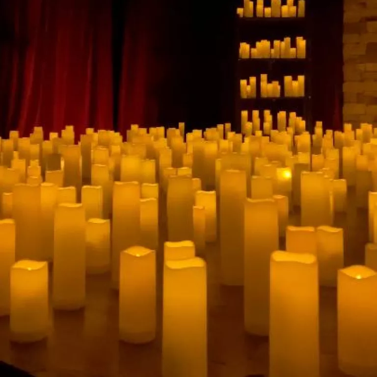 illuminating candles displayed on a stage at a candlelight concert Photo