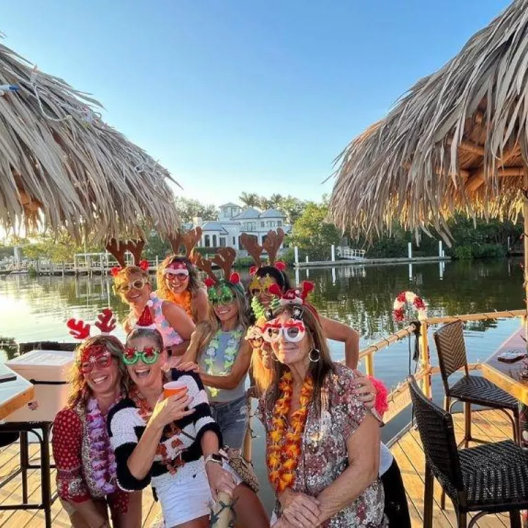 2 tiki boats together with guests sporting fun tiki glam props Photo