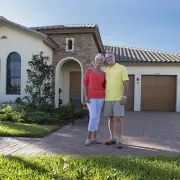 Couple standing in front of their Paradise Coast h