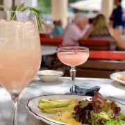 Pink drinks on a table with food
