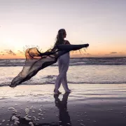 Woman walking on the beach at Sunset