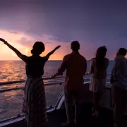 Group of meeting attendees on ship at sunset