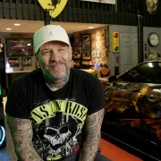 chris centrella smiles at the camera in his shop