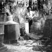 Black and White, a man surrounded by moonshine barrels Photo