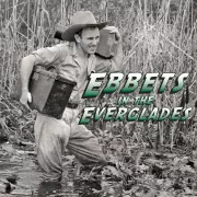 Black and white, a man lugging a camera in the everglades Photo