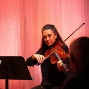 A member of the Naples Philharmonic plays the viola at a performance. Photo