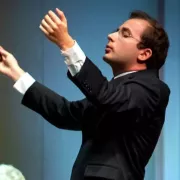 Image of Radu Paponiu, assistant conductor of the Naples Philharmonic, on stage during a performance Photo