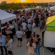a crowd of people enjoy a Florida sunset on the rooftop of the parking garage Photo