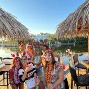 2 tiki boats together with guests sporting fun tiki glam props Photo