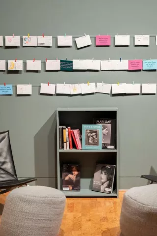 Art is displayed on a gallery wall.