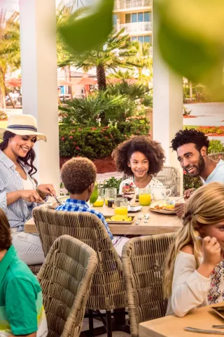 Family dining outside on a patio.