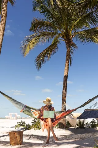 Woman on the beach with laptop