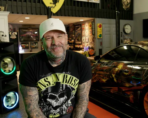 chris centrella smiles at the camera in his shop