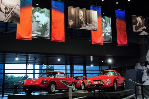 Red classic cars on display in a museum