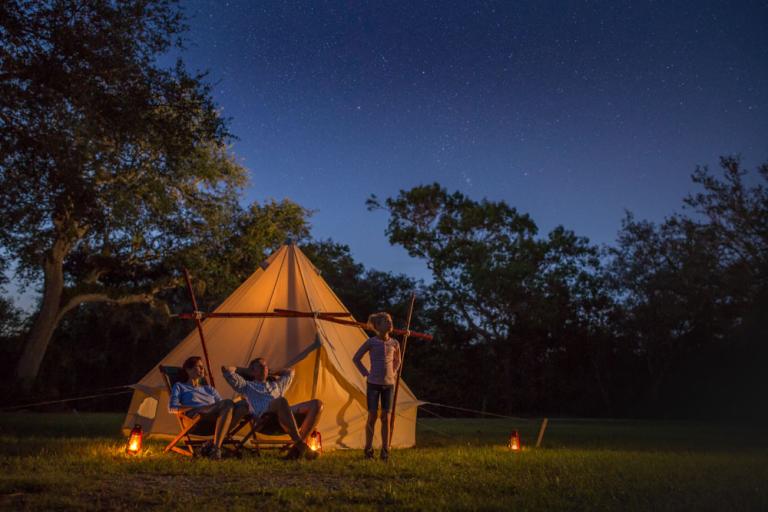 Family camping under the dark sky in Big Cypress National Preserve in Florida's Paradise Coast