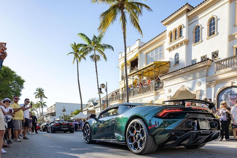 crowd admires cars on fifth avenue south