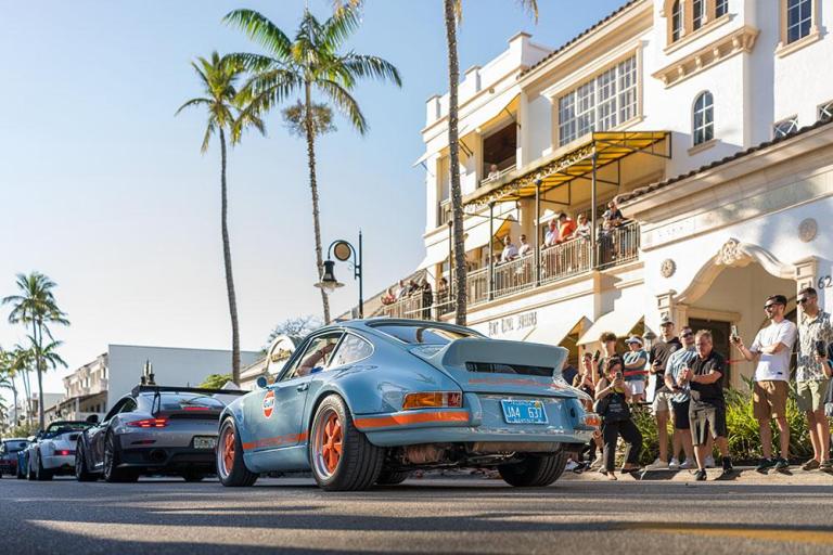 crowd admires antique porsche at cars on fifth