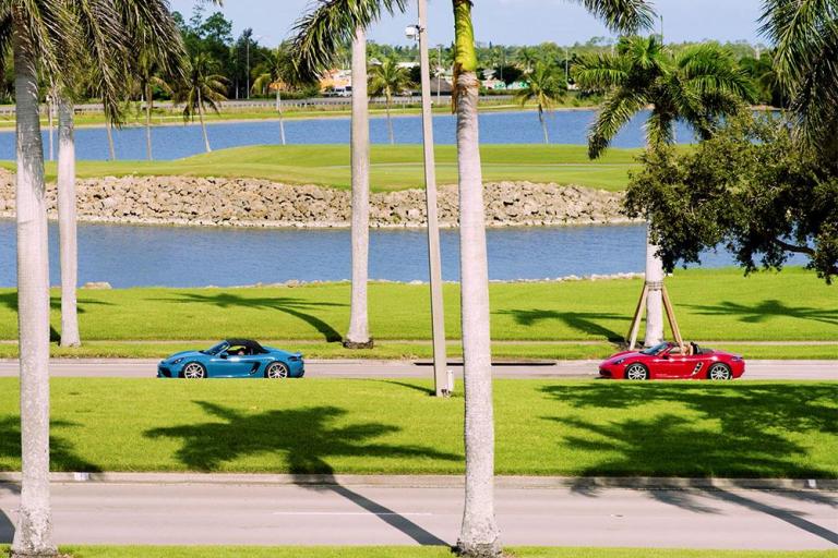 cars drive through beautiful golf course