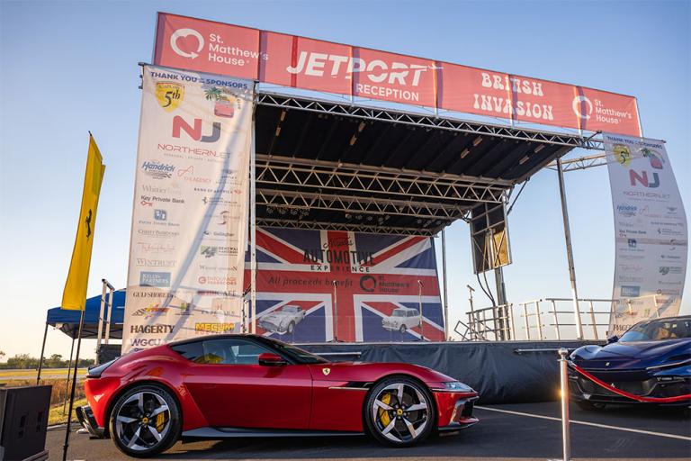 ferraris are displayed in front of outdoor stage