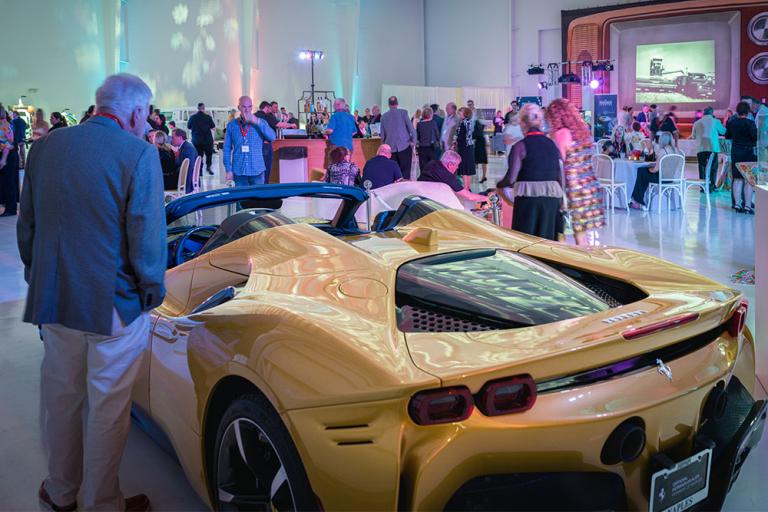 man admires yellow ferrari at jetport